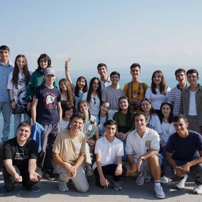 Group of Maqoor Eco Camp participants gathered on the shore of Lake Sevan, Armenia for an outdoor environmental workshop